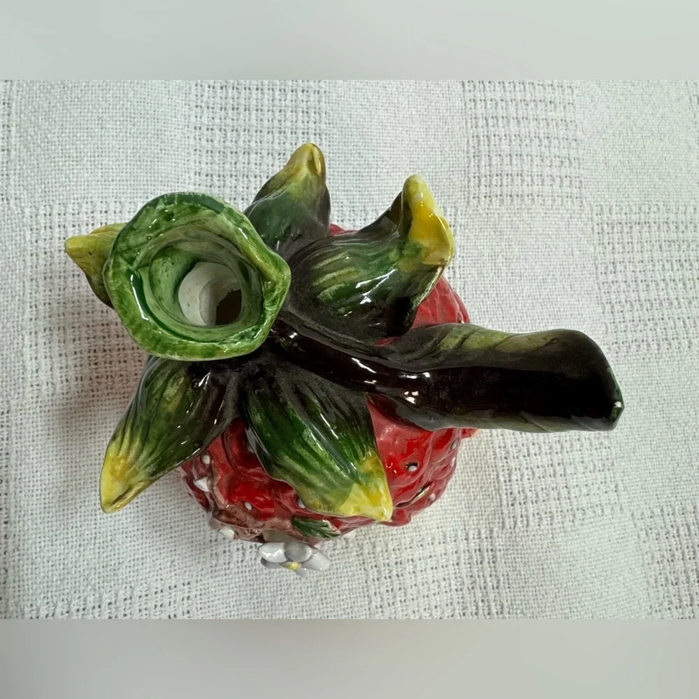 This is a vintage ceramic strawberry candle or tealight holder,